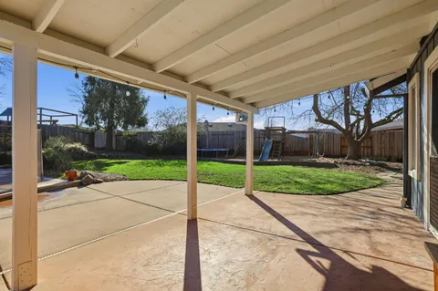 an aerial view of residential houses with outdoor space and trees