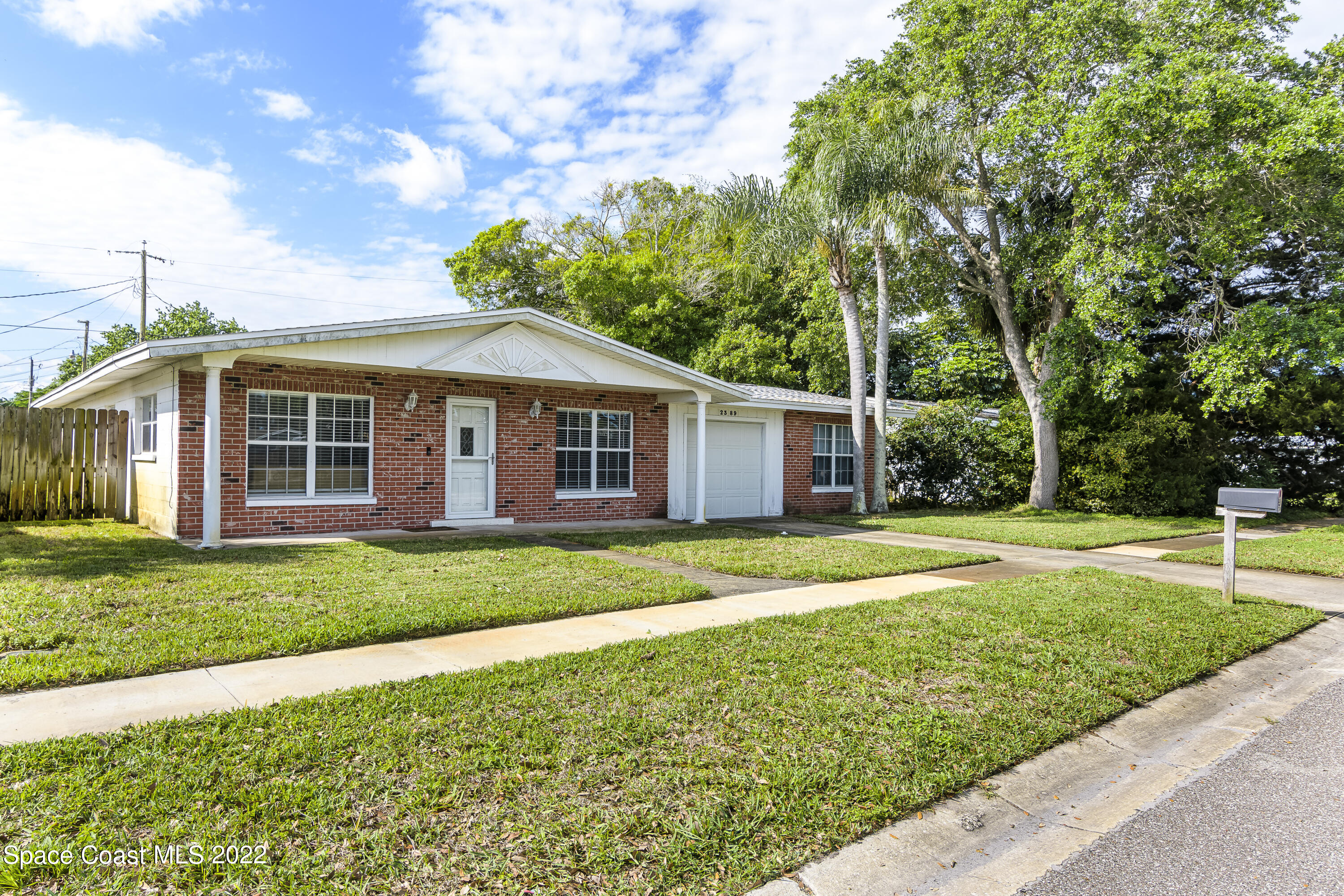 a view of a house with a backyard