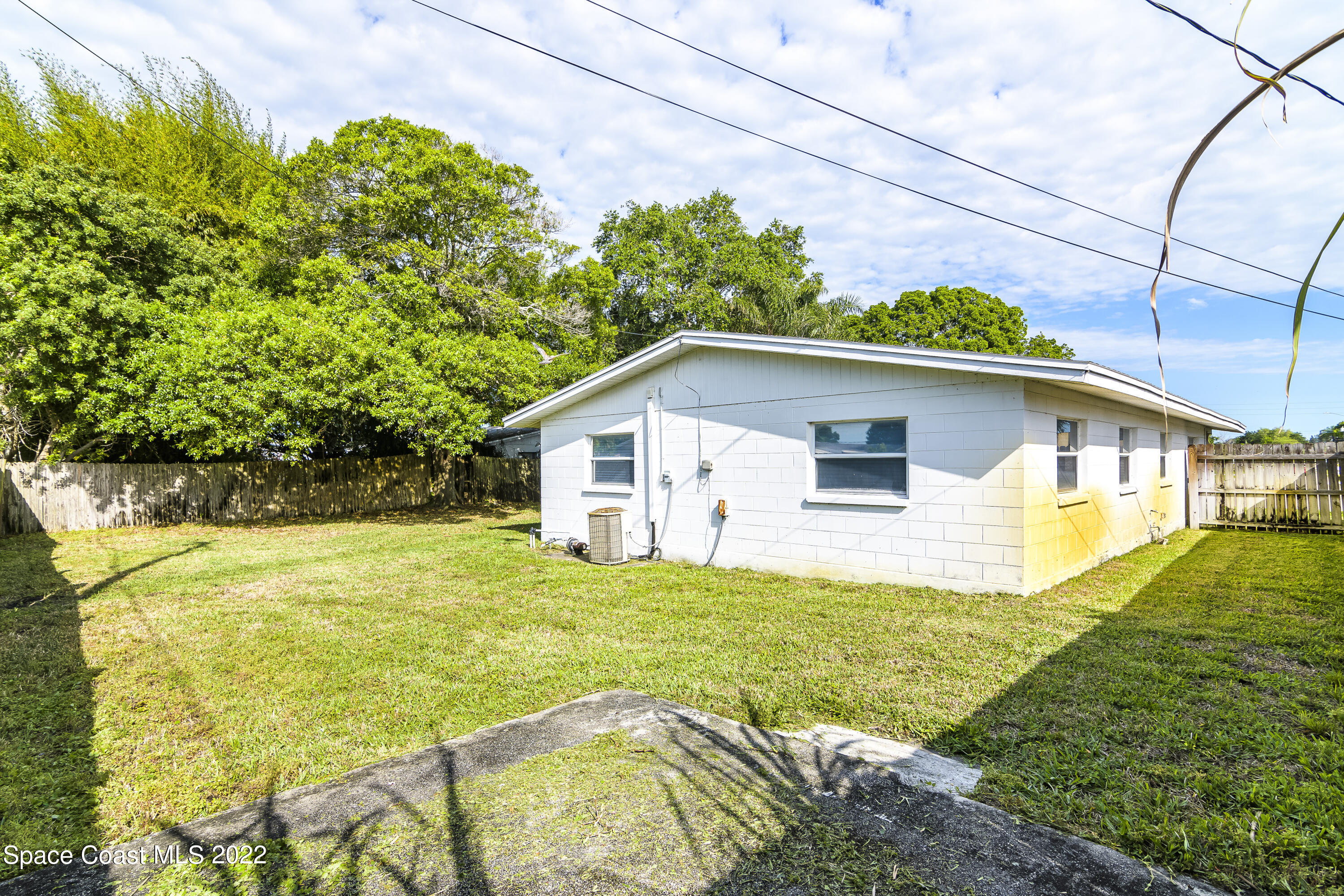 2389 Ricky Road Melbourne, FL 32935 - Photo 19 of 21 a view of a house with pool and a yard