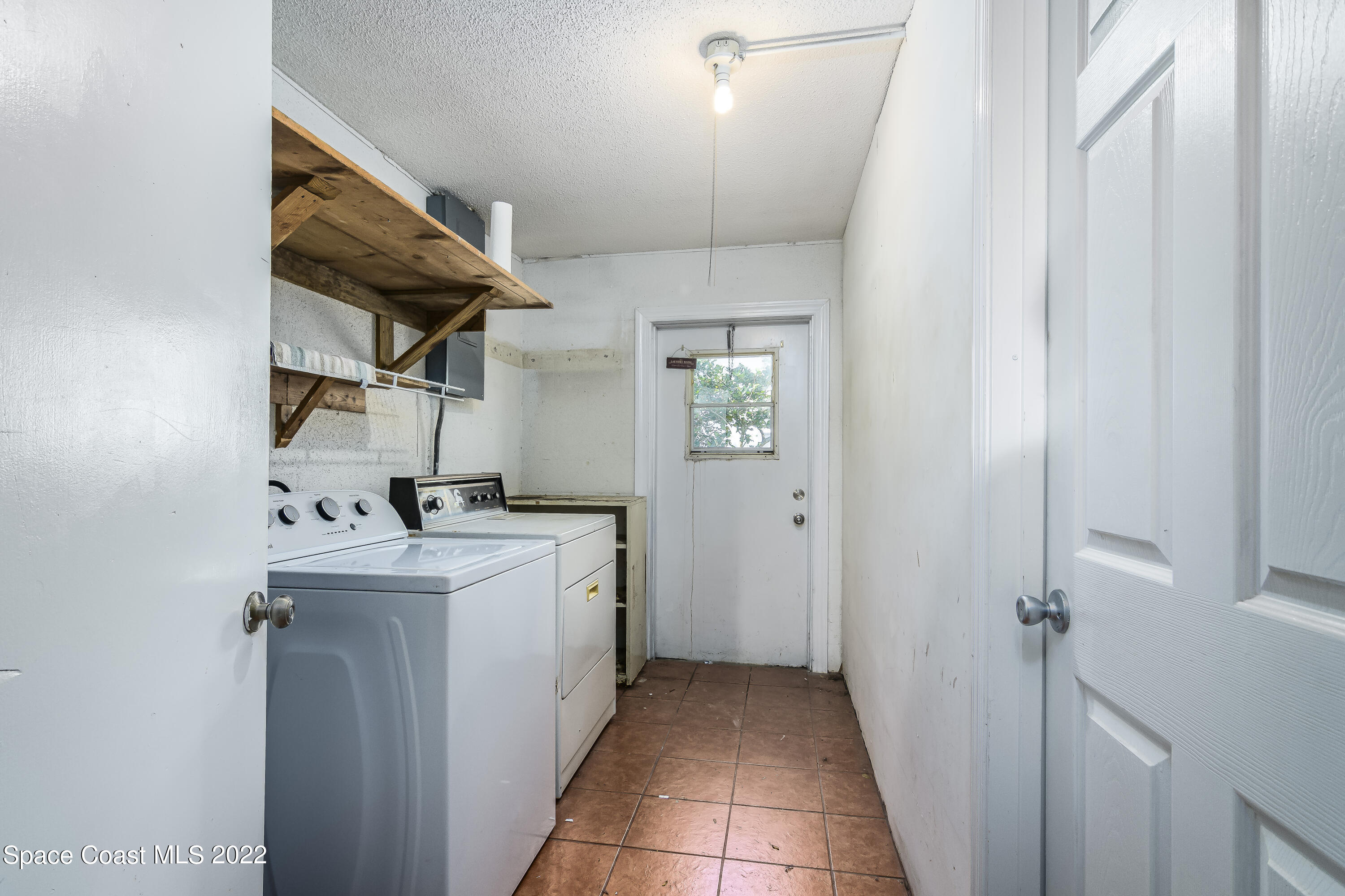 2389 Ricky Road Melbourne, FL 32935 - Photo 20 of 21 a kitchen with a sink cabinets and appliances