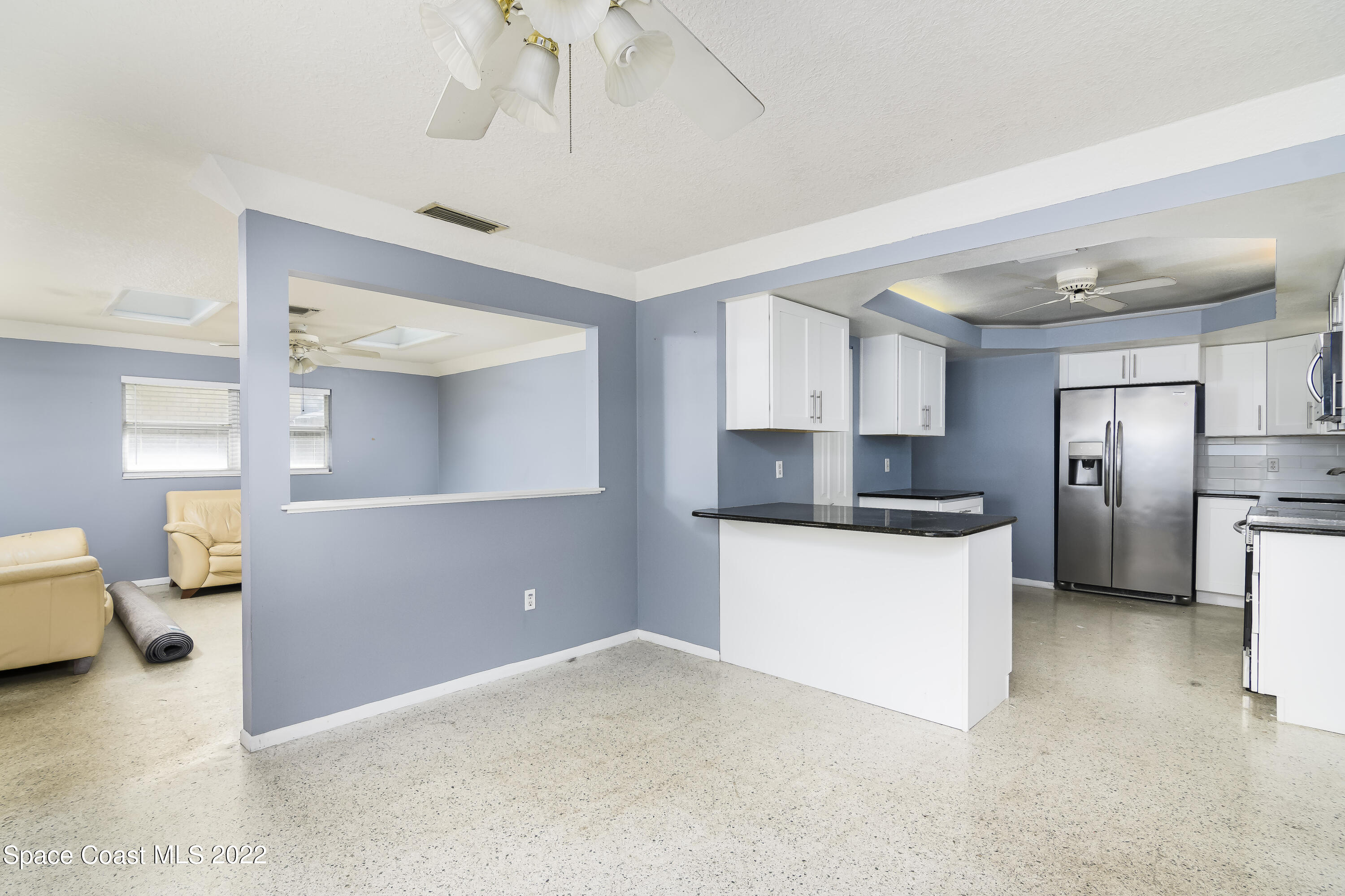 2389 Ricky Road Melbourne, FL 32935 - Photo 6 of 21 a kitchen with stainless steel appliances a refrigerator and a more cabinets
