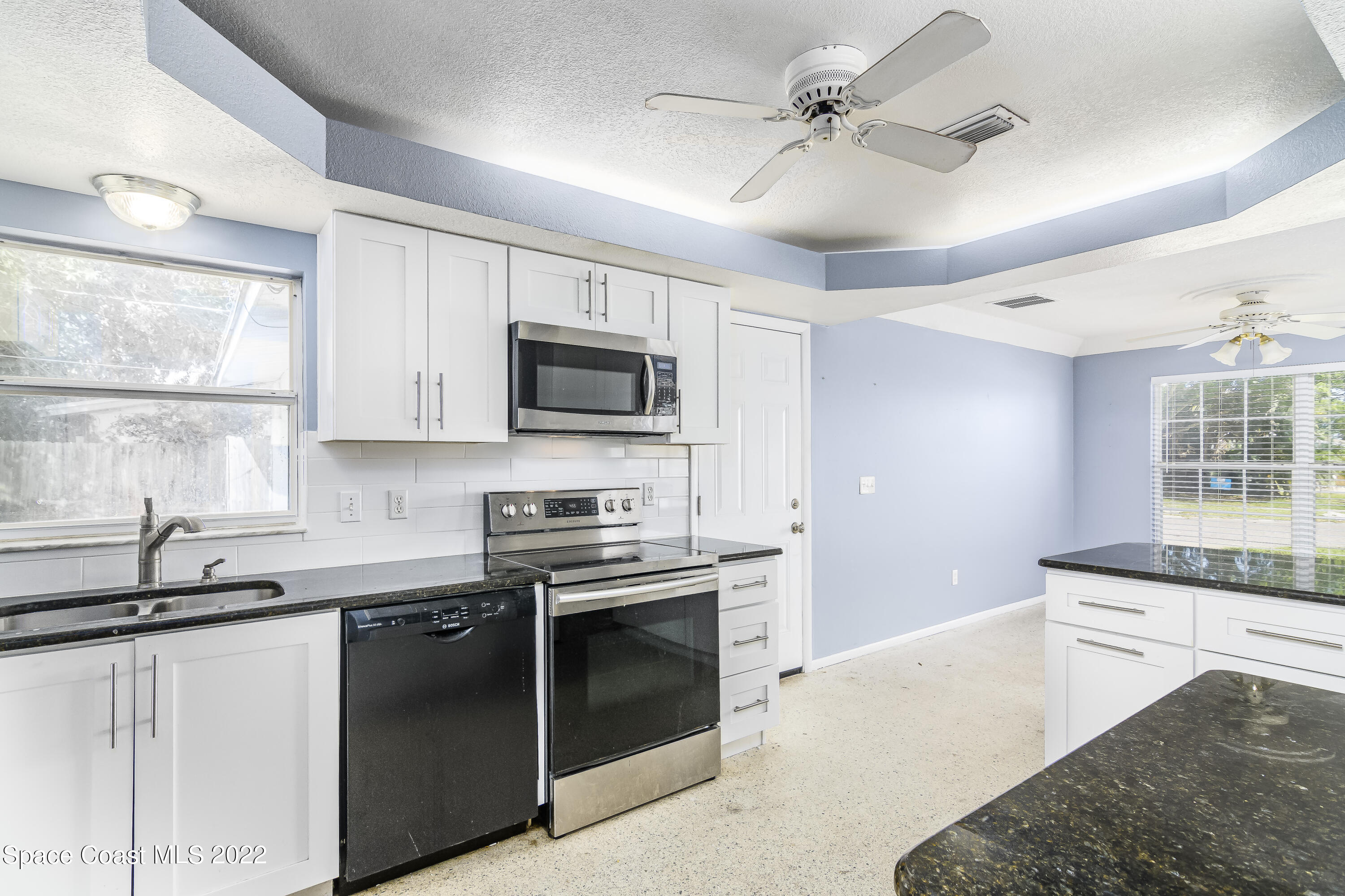 2389 Ricky Road Melbourne, FL 32935 - Photo 8 of 21 a kitchen with stainless steel appliances granite countertop a sink and a stove