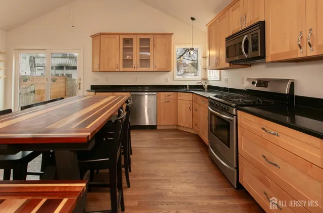 a kitchen with stainless steel appliances granite countertop a stove and a sink