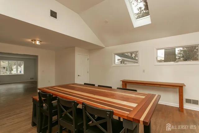 a bedroom with a bed and paintings on the wall