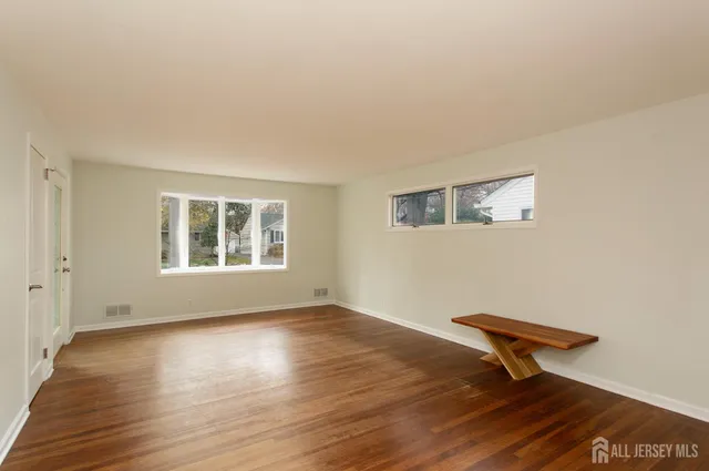 a bench sitting in a room next to a window