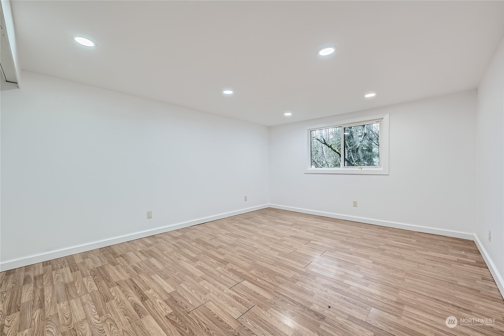 1332 192nd Street Southeast, Unit 17 Bothell, WA 98012 - Photo 11 of 24 an empty room with wooden floor and windows