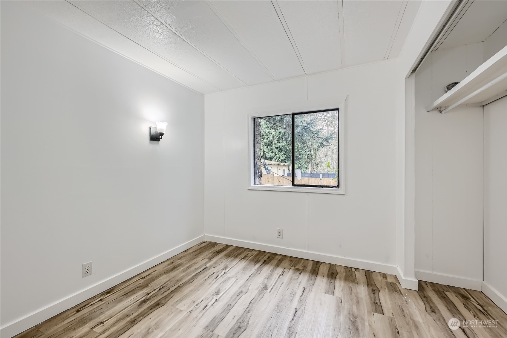 1332 192nd Street Southeast, Unit 17 Bothell, WA 98012 - Photo 19 of 24 an empty room with a window and wooden floor