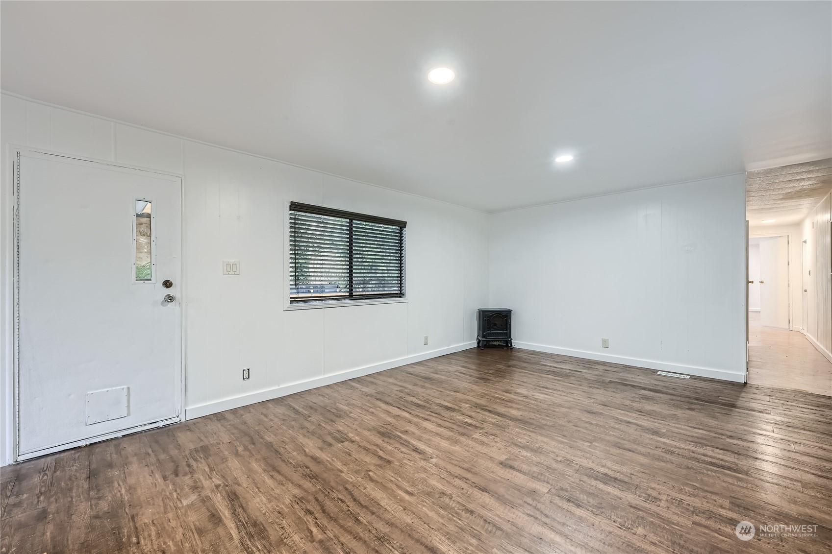 1332 192nd Street Southeast, Unit 17 Bothell, WA 98012 - Photo 4 of 24 an empty room with wooden floor and windows