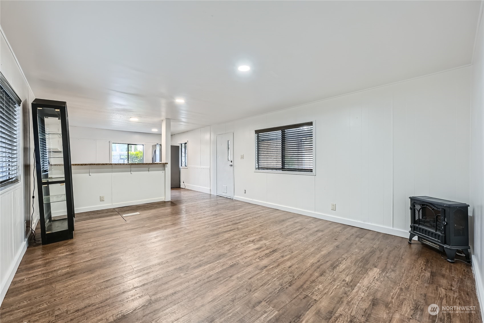 1332 192nd Street Southeast, Unit 17 Bothell, WA 98012 - Photo 5 of 24 a view of a big room with wooden floor and a kitchen