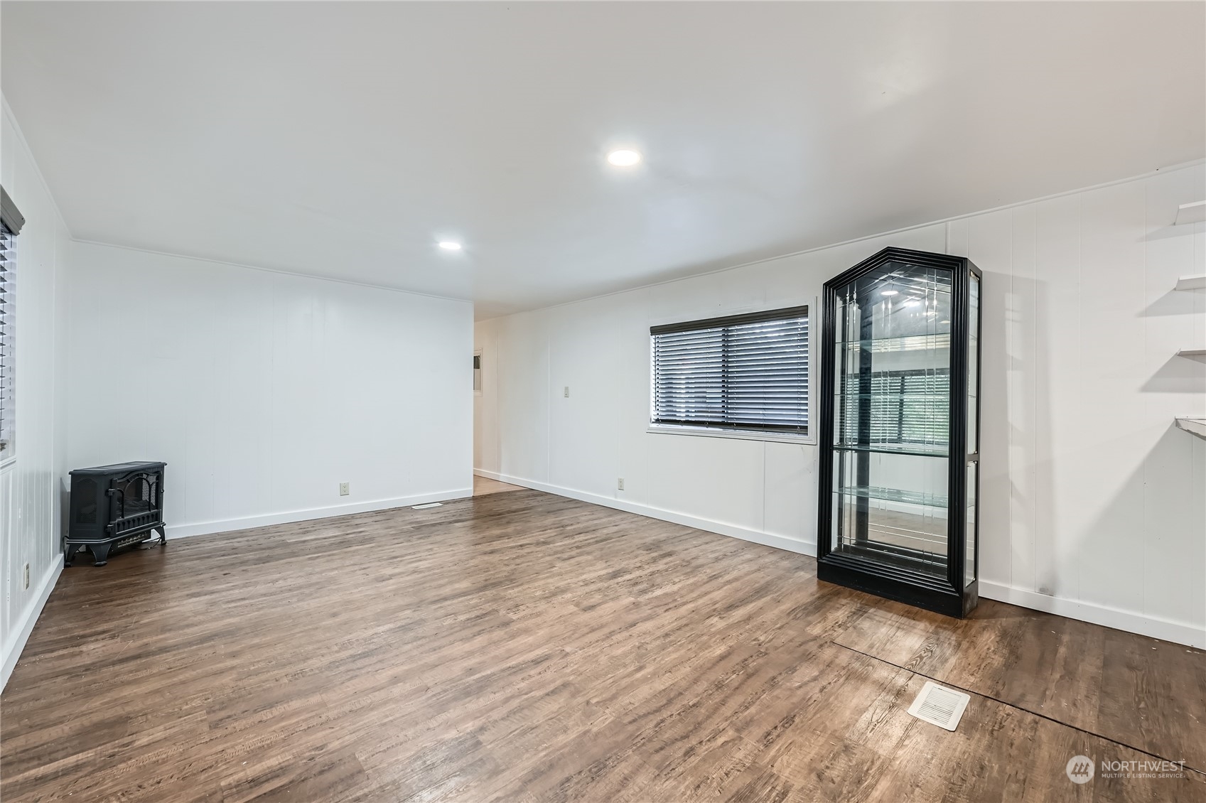 1332 192nd Street Southeast, Unit 17 Bothell, WA 98012 - Photo 6 of 24 an empty room with wooden floor and windows
