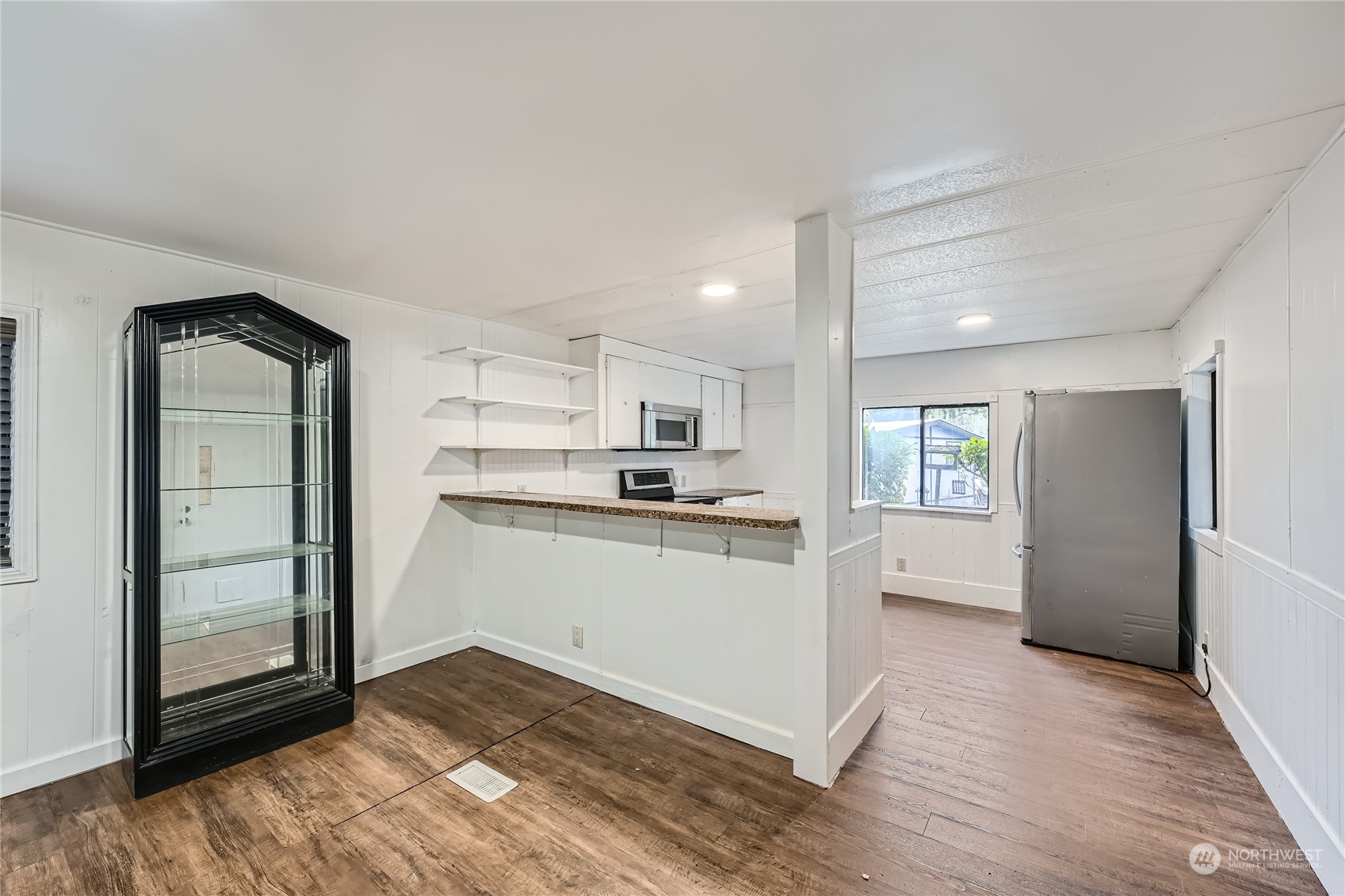 1332 192nd Street Southeast, Unit 17 Bothell, WA 98012 - Photo 8 of 24 a kitchen with a refrigerator and white cabinets