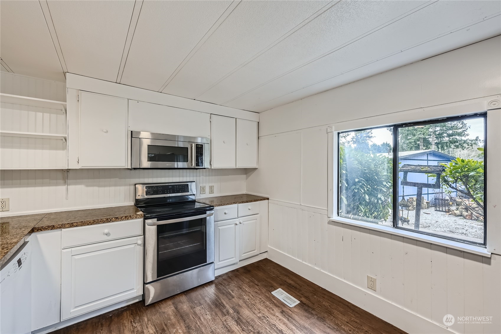 1332 192nd Street Southeast, Unit 17 Bothell, WA 98012 - Photo 10 of 24 a kitchen with stainless steel appliances white cabinets a sink and a stove