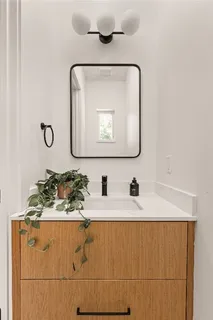 a bathroom with a sink vanity and mirror