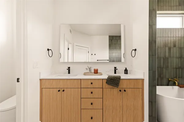 a bathroom with a sink a toilet and shower