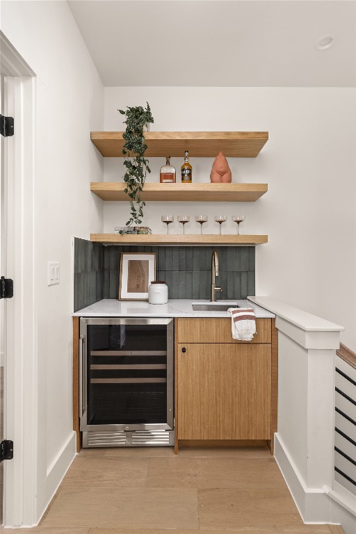 4530 Clawson Road, Unit 1 Austin, TX 78745 - Photo 24 of 24 Bar with beverage cooler, light wood-type flooring, open shelves, light stone counters, and modern cabinets