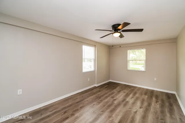 a view of a room with a window and a ceiling fan
