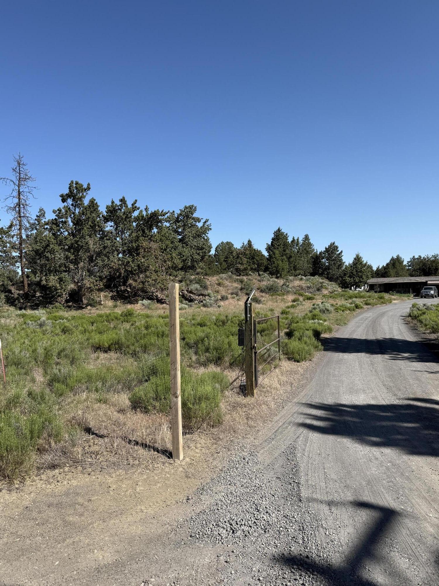 21710 McGilvray Road Bend, OR 97702 - Photo 1 of 7 a view of a road with a yard