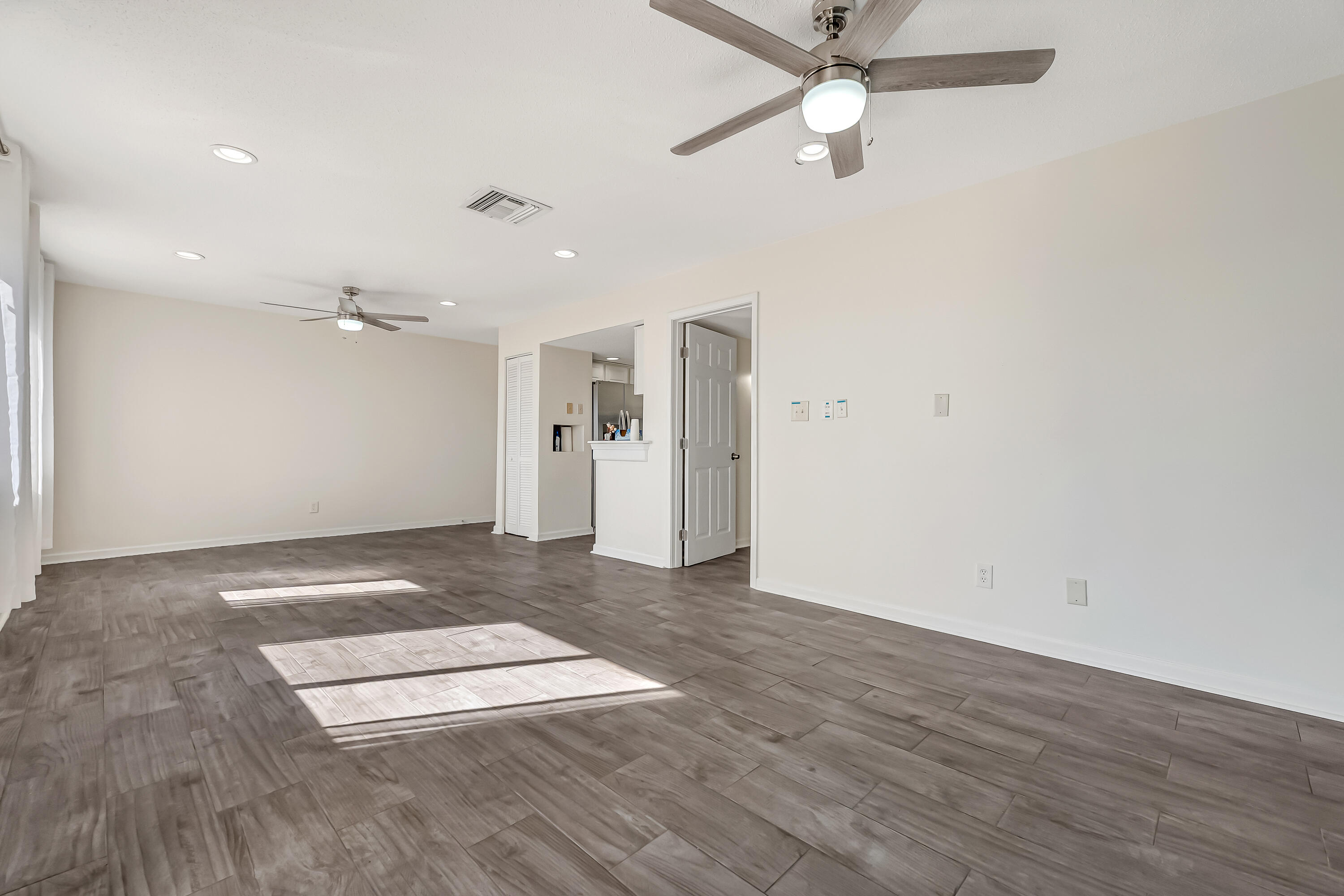 101 Old Ferry Road, Unit 20B Shalimar, FL 32579 - Photo 11 of 30 an empty room with wooden floor ceiling fan and window