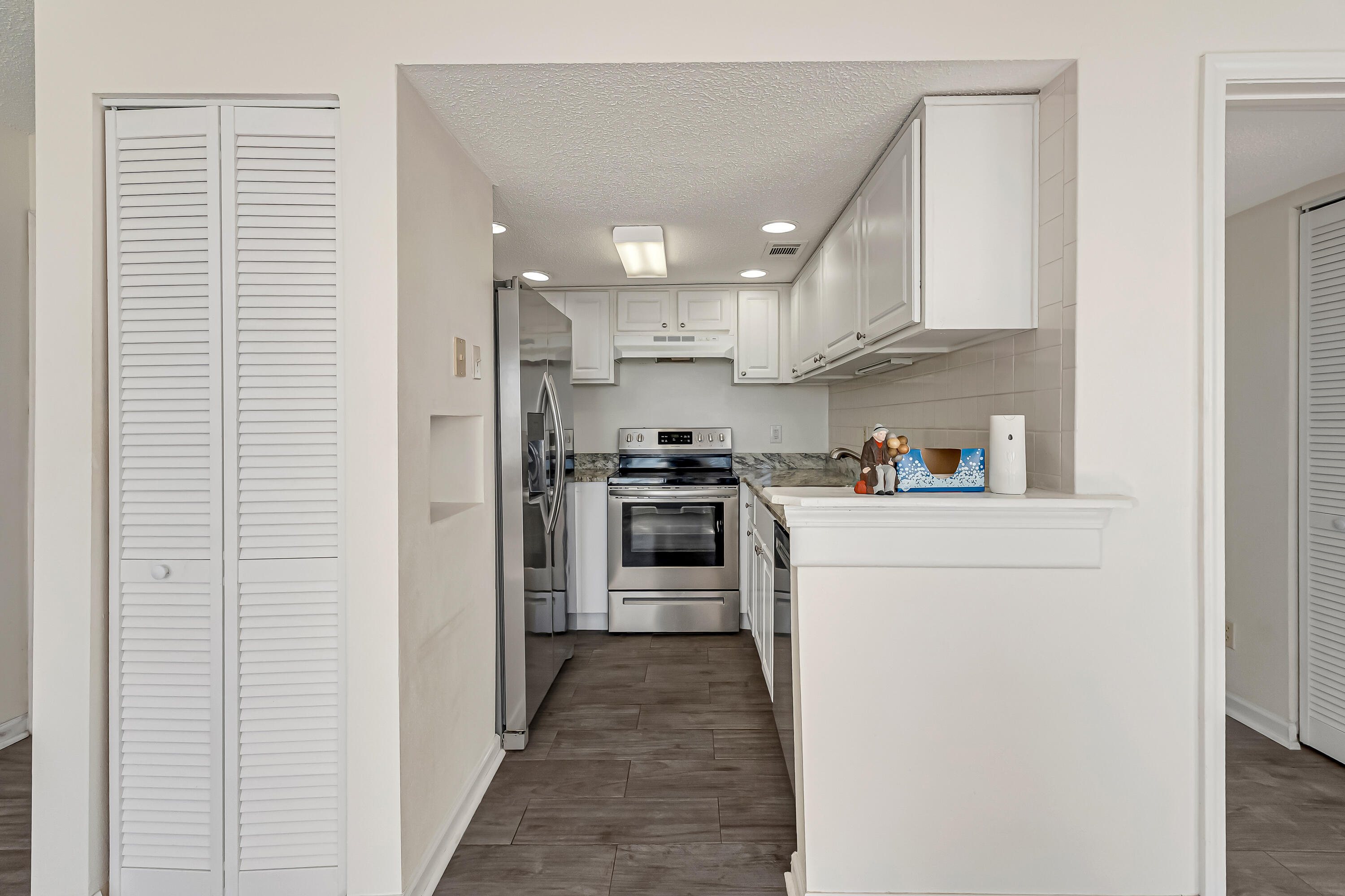 101 Old Ferry Road, Unit 20B Shalimar, FL 32579 - Photo 12 of 30 a kitchen with cabinets and stainless steel appliances