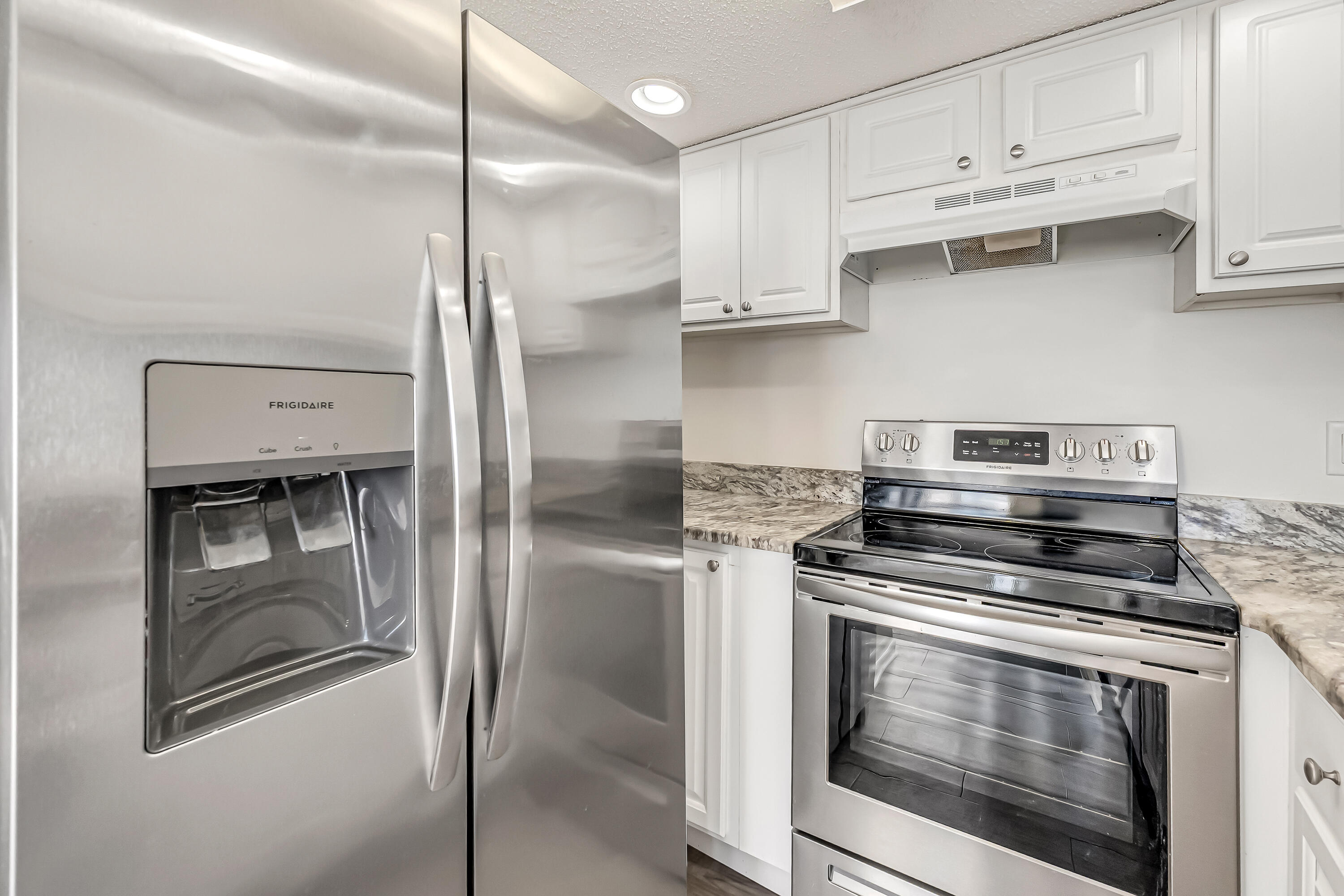 101 Old Ferry Road, Unit 20B Shalimar, FL 32579 - Photo 17 of 30 a kitchen with stainless steel appliances granite countertop a stove and a refrigerator