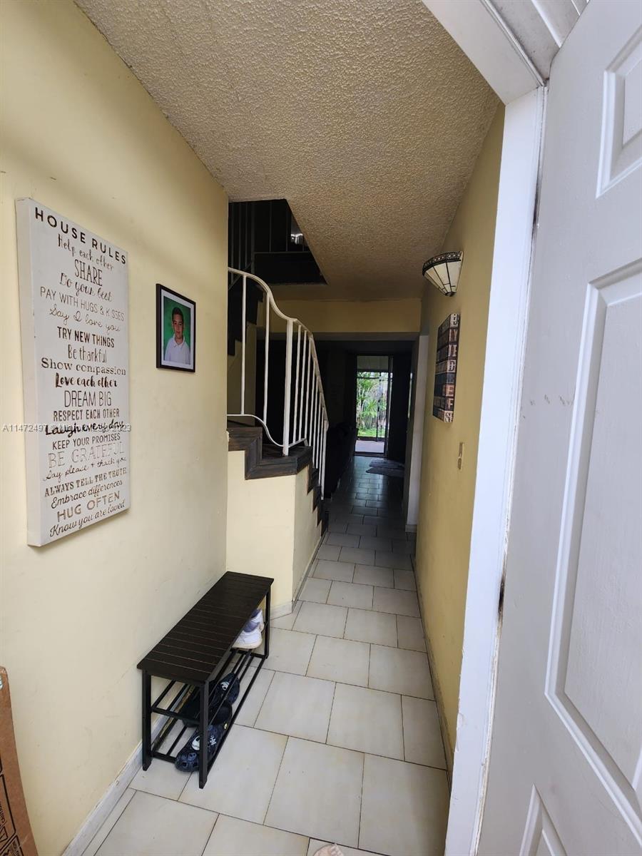 Mango Hill Hialeah, FL 33012 - Photo 1 of 18 a hallway with a couple of white walls and a refrigerator