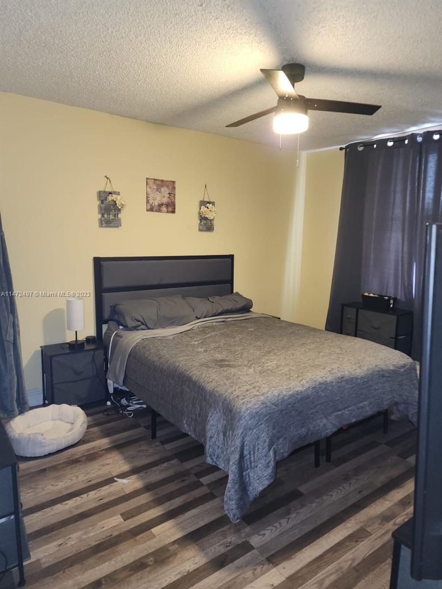 Mango Hill Hialeah, FL 33012 - Photo 11 of 18 a bedroom with a bed and a mirror