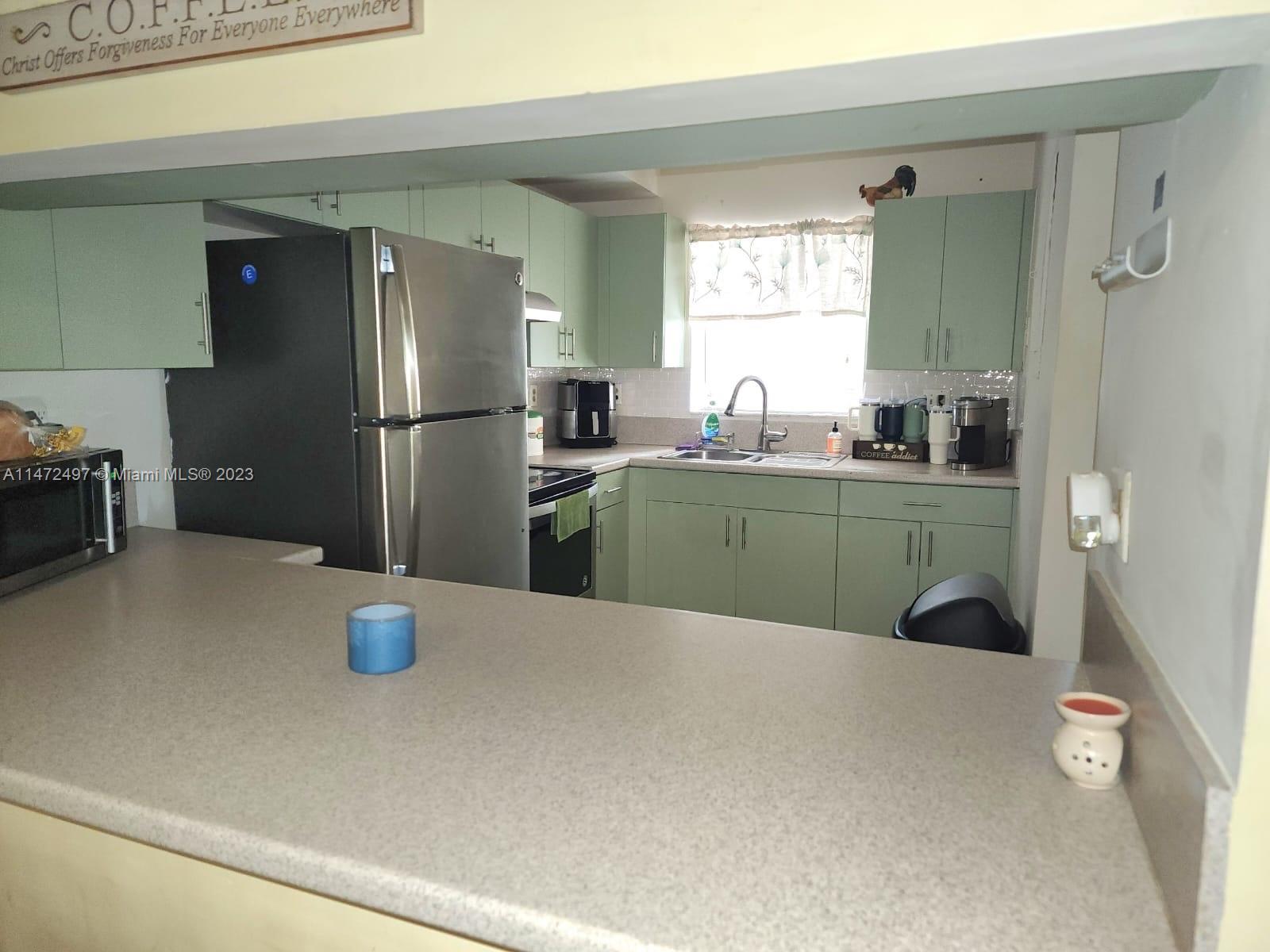 Mango Hill Hialeah, FL 33012 - Photo 6 of 18 a kitchen with a refrigerator and a sink