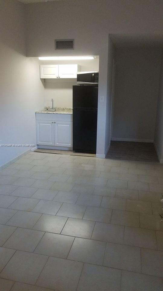 Mango Hill Hialeah, FL 33012 - Photo 8 of 18 a view of a refrigerator and window in a room