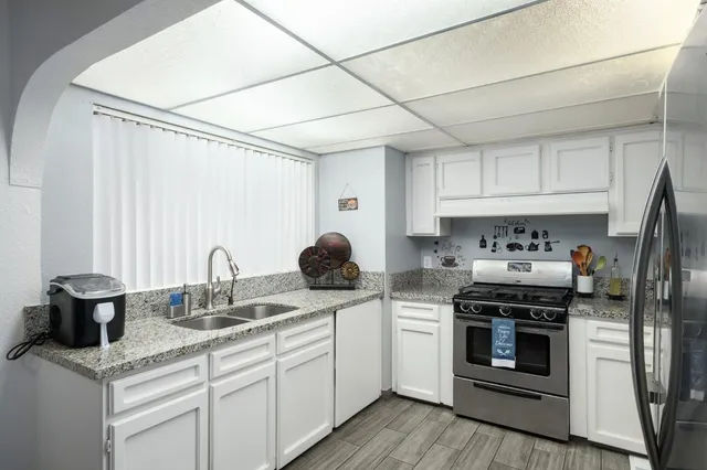 a kitchen with appliances cabinets and a sink