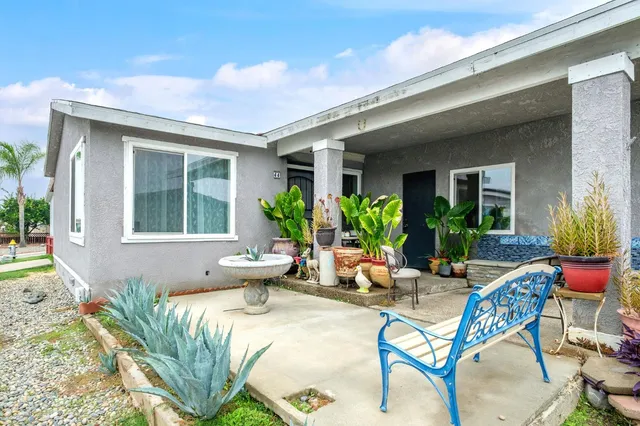 a view of a house with backyard sitting area and garden
