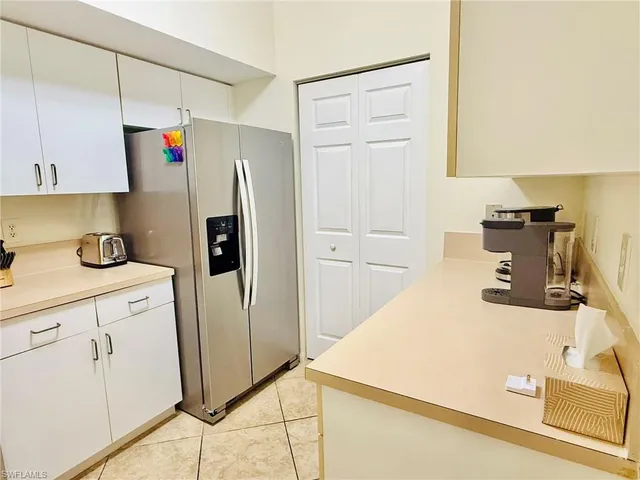 a kitchen with stainless steel appliances a refrigerator and cabinets
