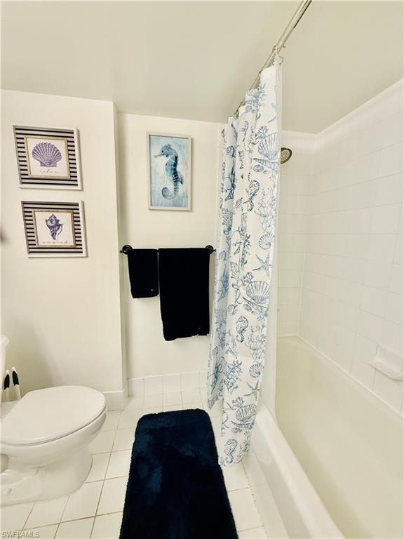 1820 Florida Club Circle, Unit 2210 Naples, FL 34112 - Photo 17 of 37 Bathroom featuring shower / bathtub combination with curtain and tile patterned floors