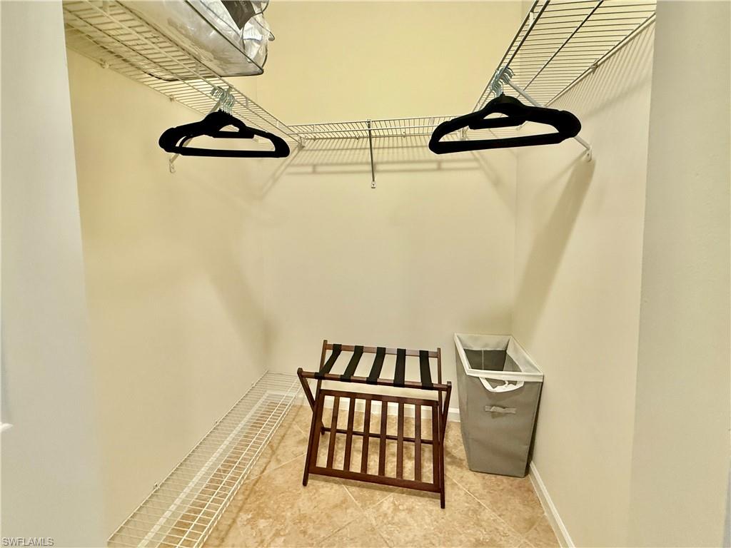 1820 Florida Club Circle, Unit 2210 Naples, FL 34112 - Photo 18 of 37 Spacious closet with tile patterned floors