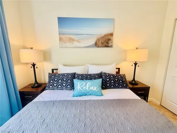 a bedroom with a bed and a night stand