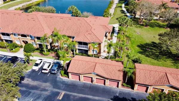 an aerial view of a house with garden space and lake view