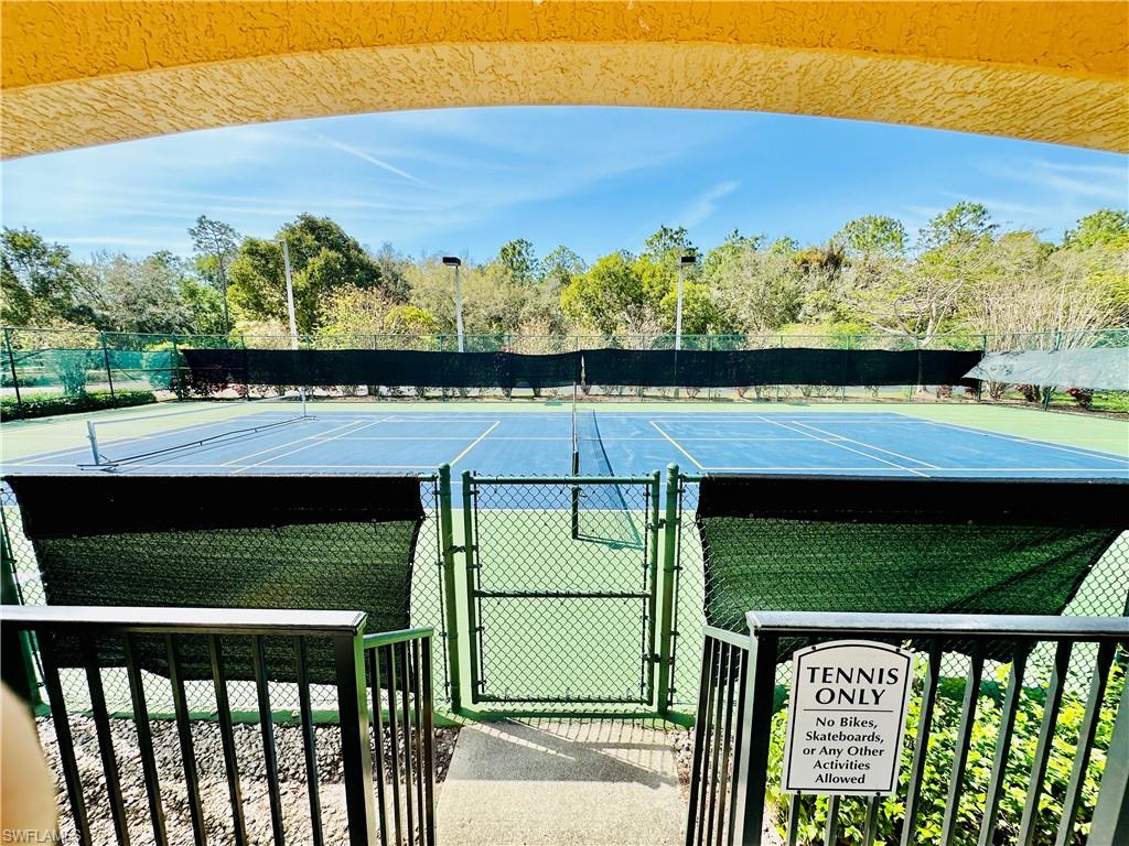 1820 Florida Club Circle, Unit 2210 Naples, FL 34112 - Photo 28 of 37 View of tennis court featuring a gate