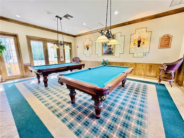 a living room with furniture and a book shelf