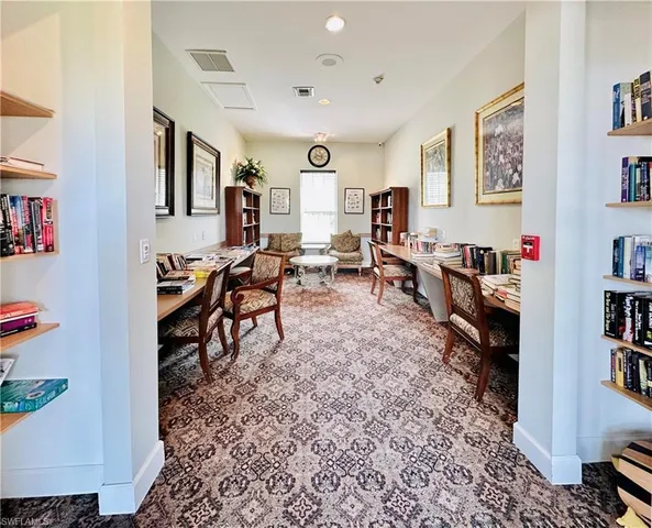 a dining hall with stainless steel appliances granite countertop a sink a dining table and chairs