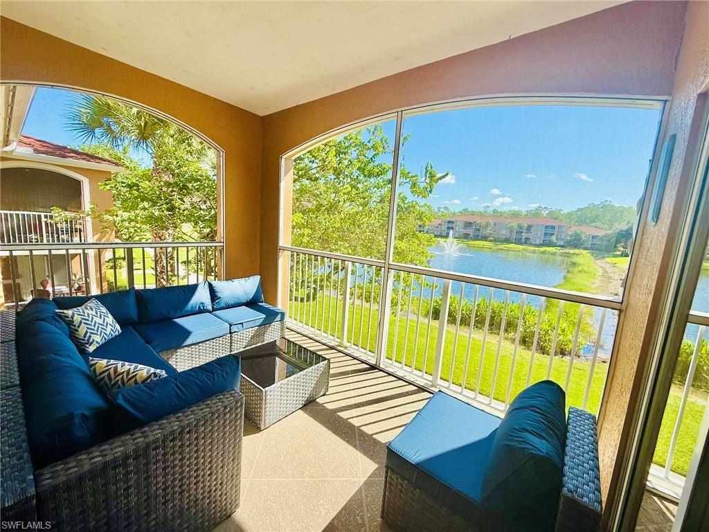 1820 Florida Club Circle, Unit 2210 Naples, FL 34112 - Photo 6 of 37 Balcony with a sunroom, a water view, and an outdoor living space