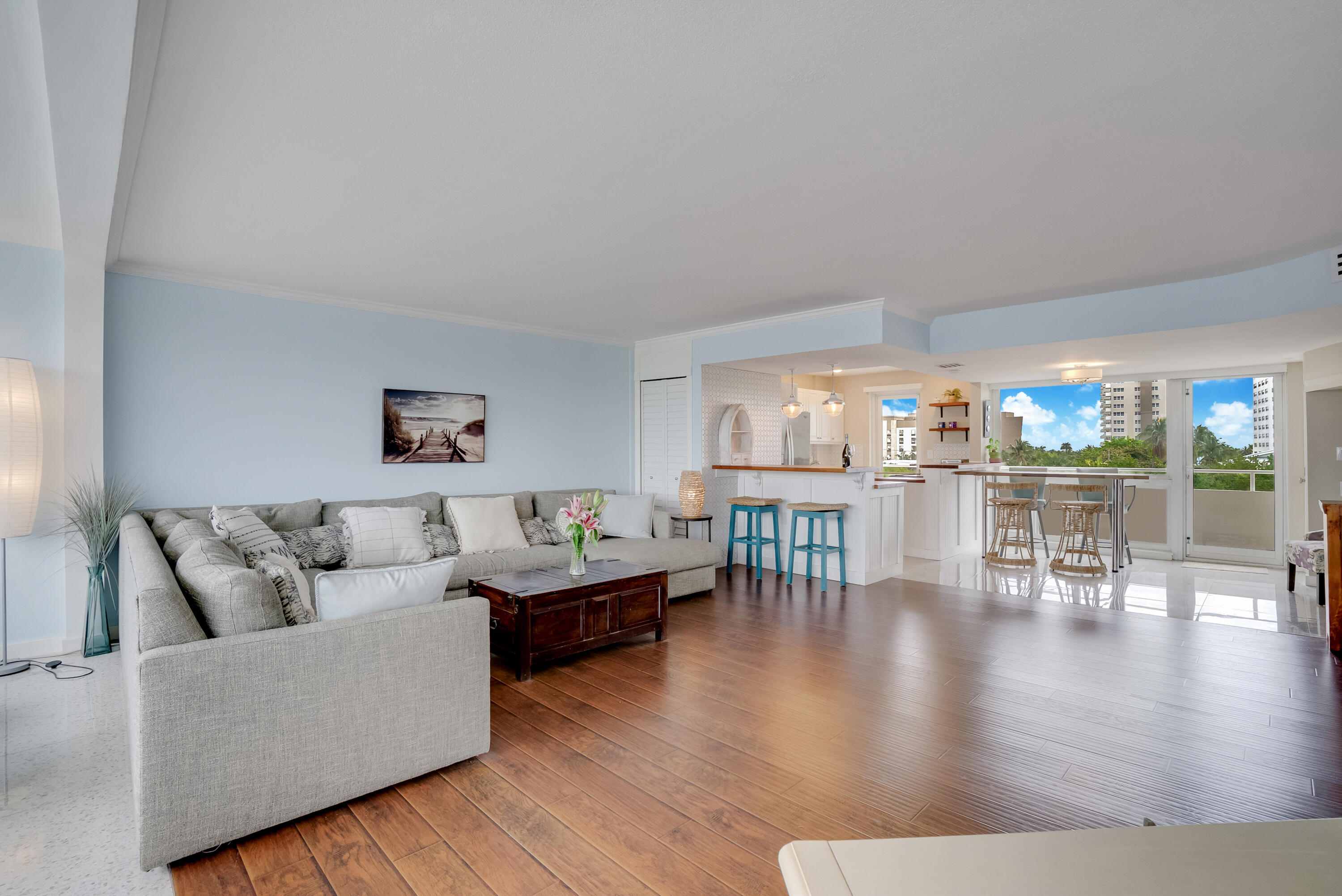 201 North Riverside Drive, Unit 402 Pompano Beach, FL 33062 - Photo 19 of 30 a living room with furniture and a table with wooden floor
