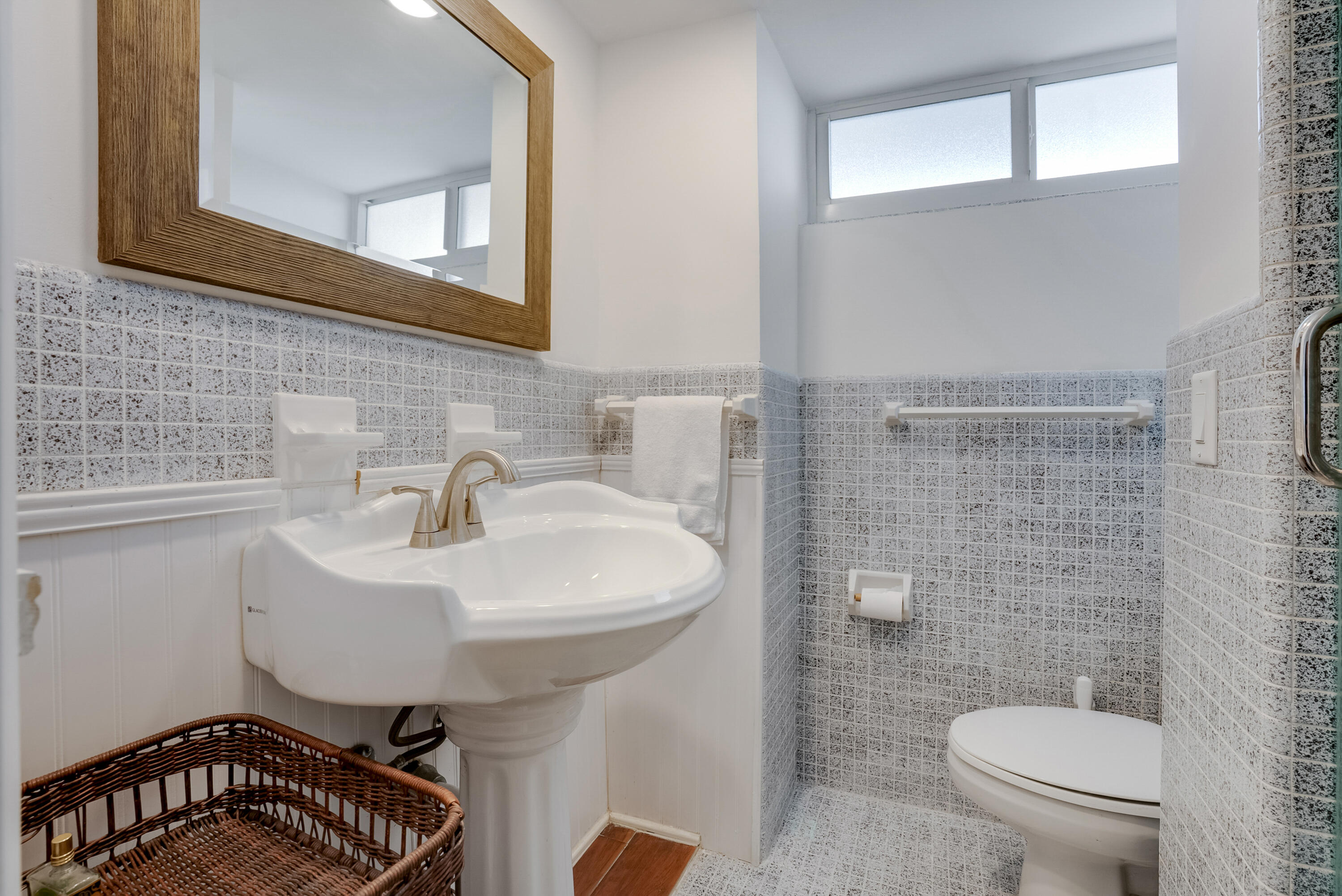 201 North Riverside Drive, Unit 402 Pompano Beach, FL 33062 - Photo 20 of 30 a bathroom with a sink a toilet and mirror