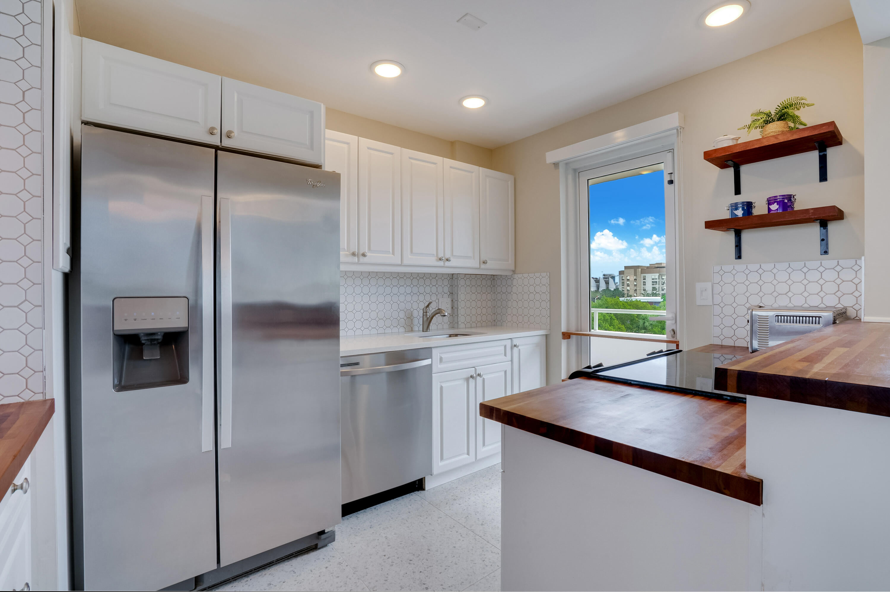 201 North Riverside Drive, Unit 402 Pompano Beach, FL 33062 - Photo 25 of 30 a kitchen with kitchen island a counter top space cabinets and stainless steel appliances