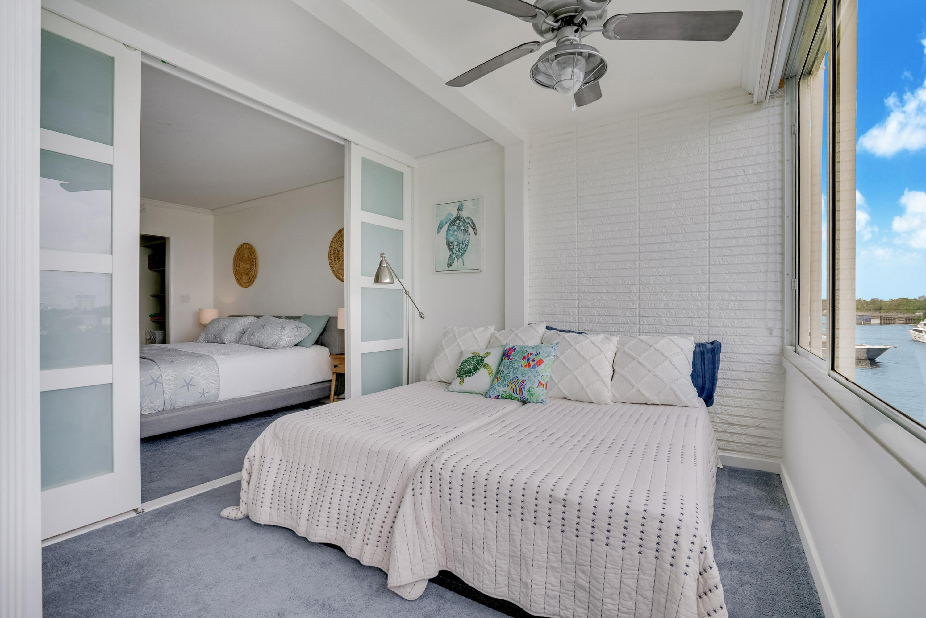 201 North Riverside Drive, Unit 402 Pompano Beach, FL 33062 - Photo 28 of 30 a bedroom with a bed and ceiling fan