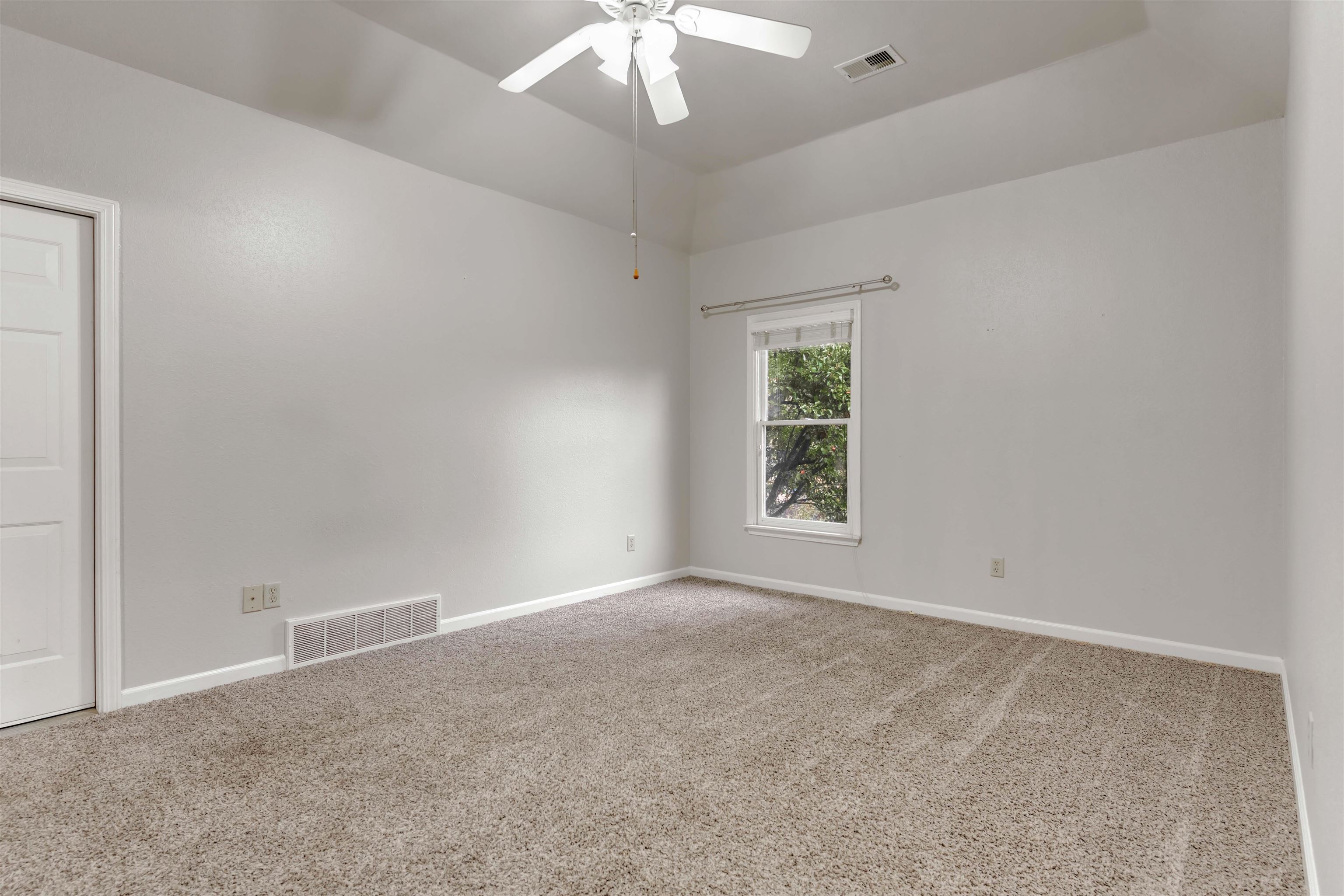 1335 Riding Brook Drive Collierville, TN 38017 - Photo 22 of 32 an empty room with windows and chandelier fan