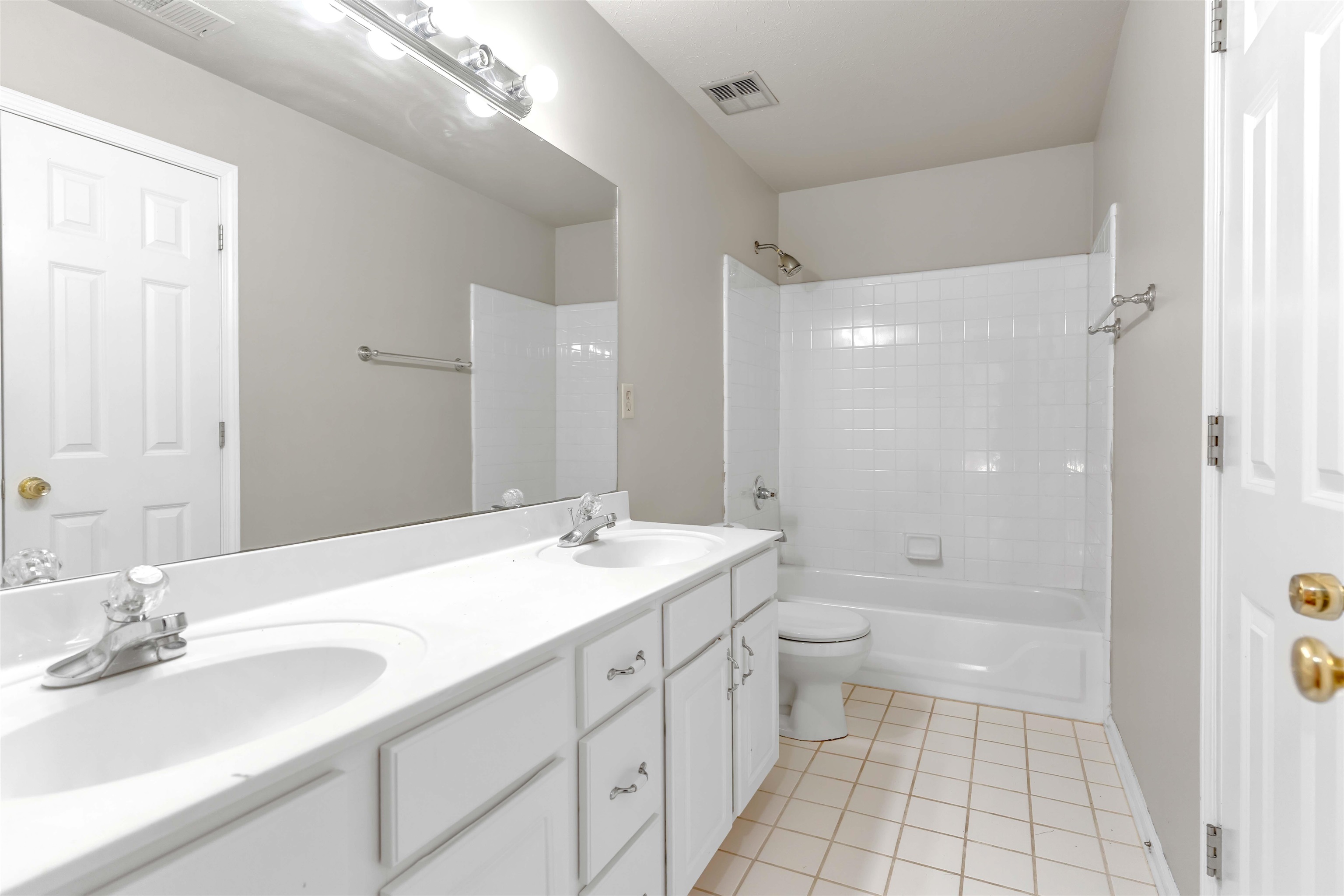 1335 Riding Brook Drive Collierville, TN 38017 - Photo 23 of 32 Full bathroom with light tile patterned floors, double vanity, and tub / shower combination