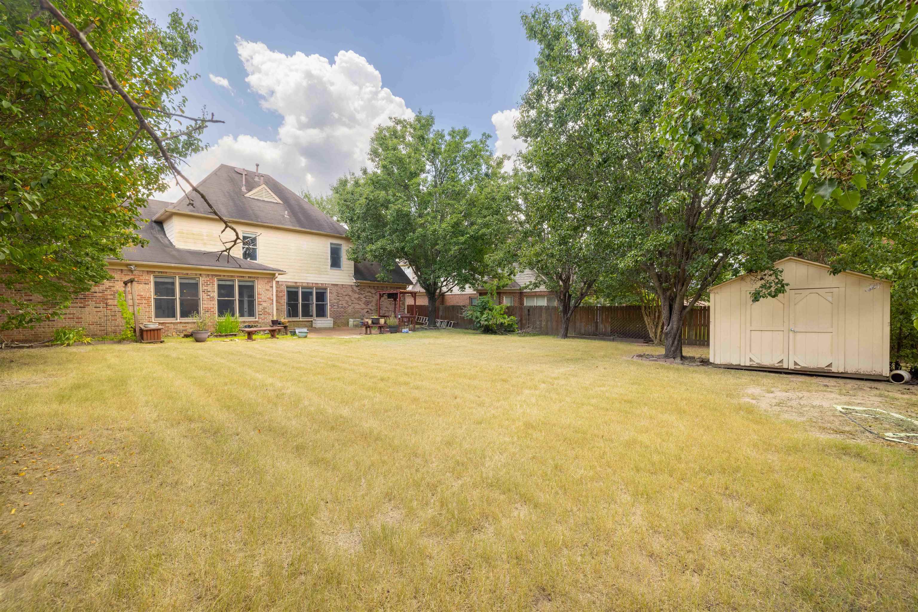 1335 Riding Brook Drive Collierville, TN 38017 - Photo 26 of 32 a front view of a house with a yard and garage