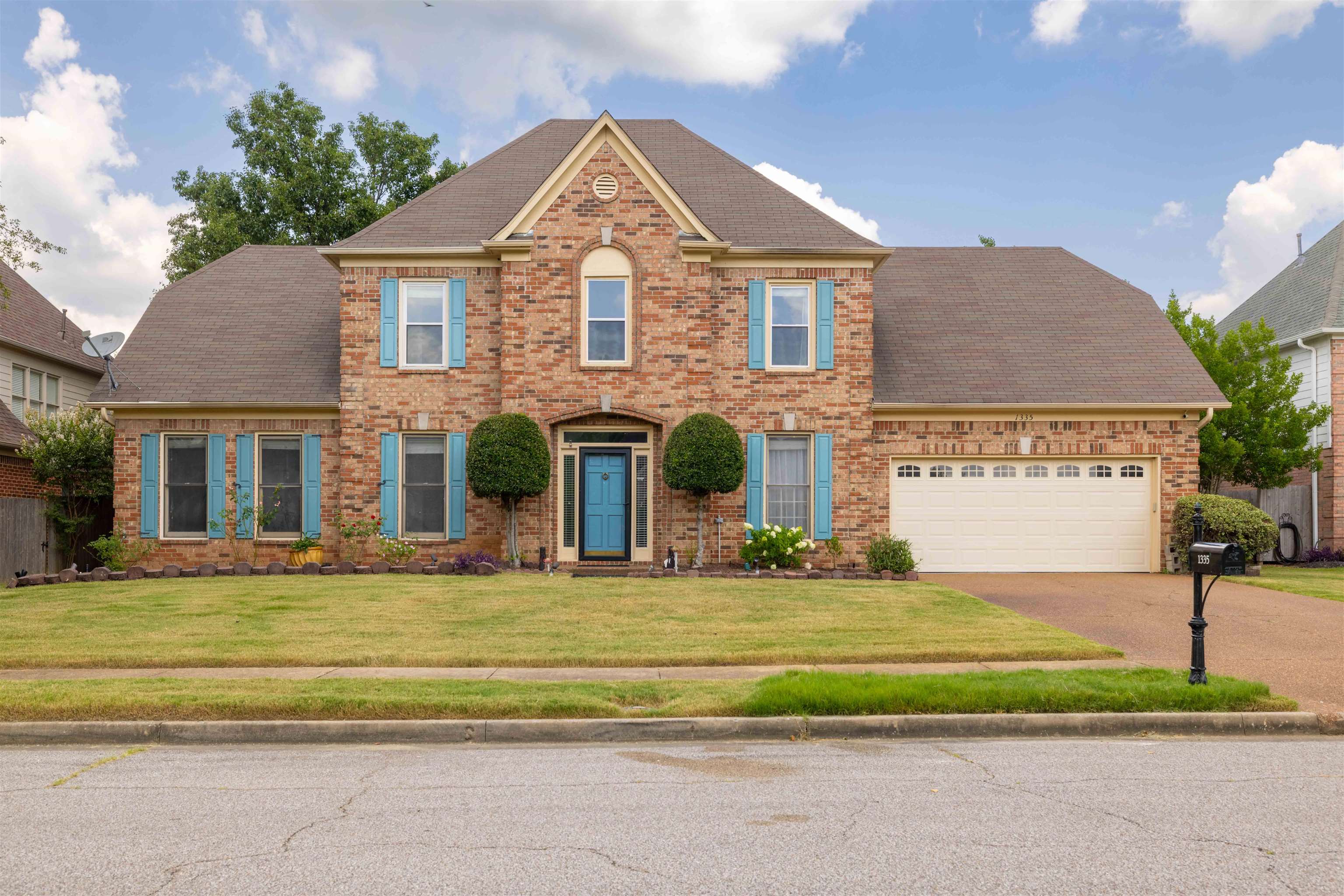 1335 Riding Brook Drive Collierville, TN 38017 - Photo 29 of 32 a front view of a house with a yard