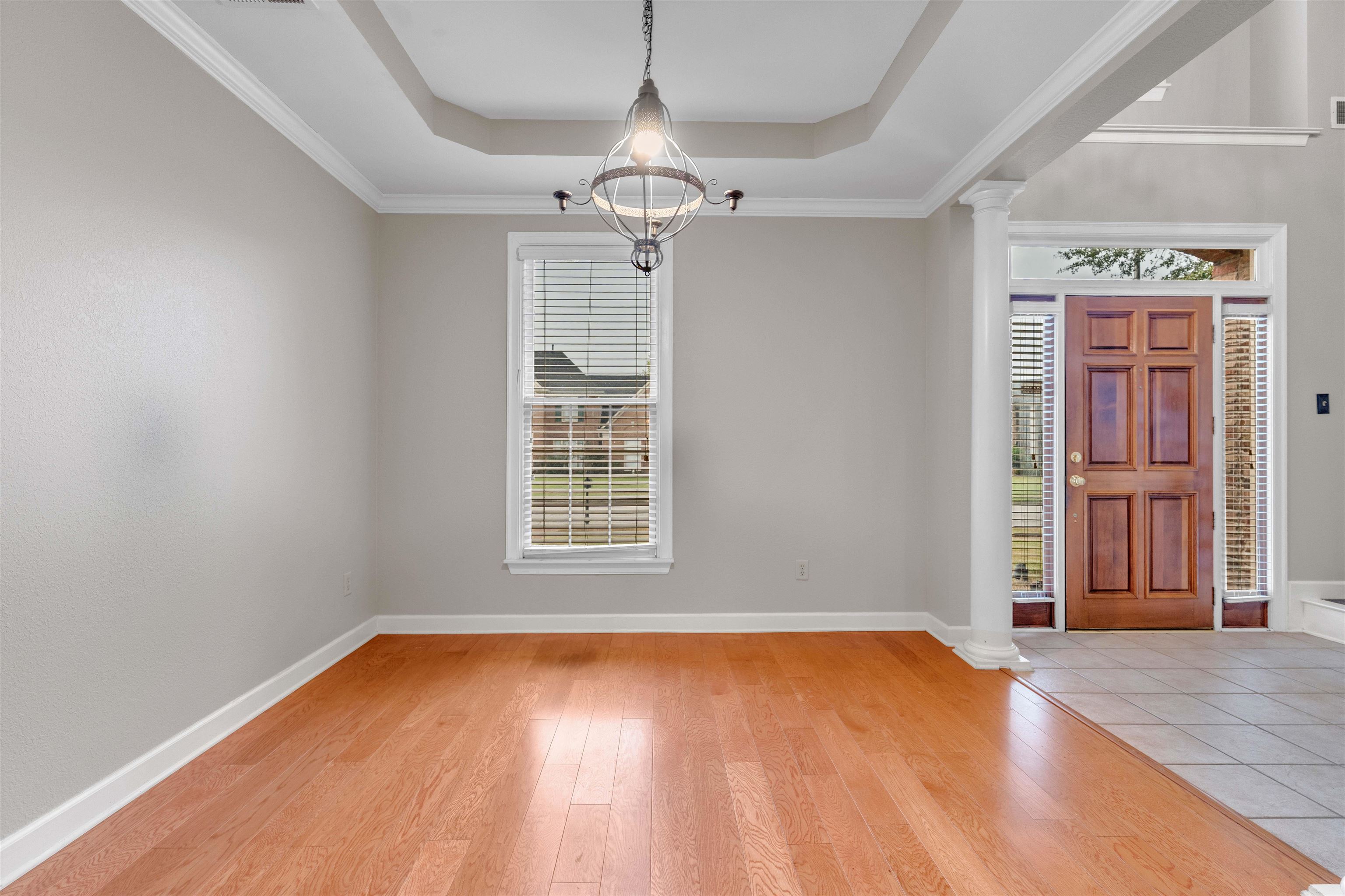 1335 Riding Brook Drive Collierville, TN 38017 - Photo 5 of 32 an empty room with wooden floor cabinet and windows