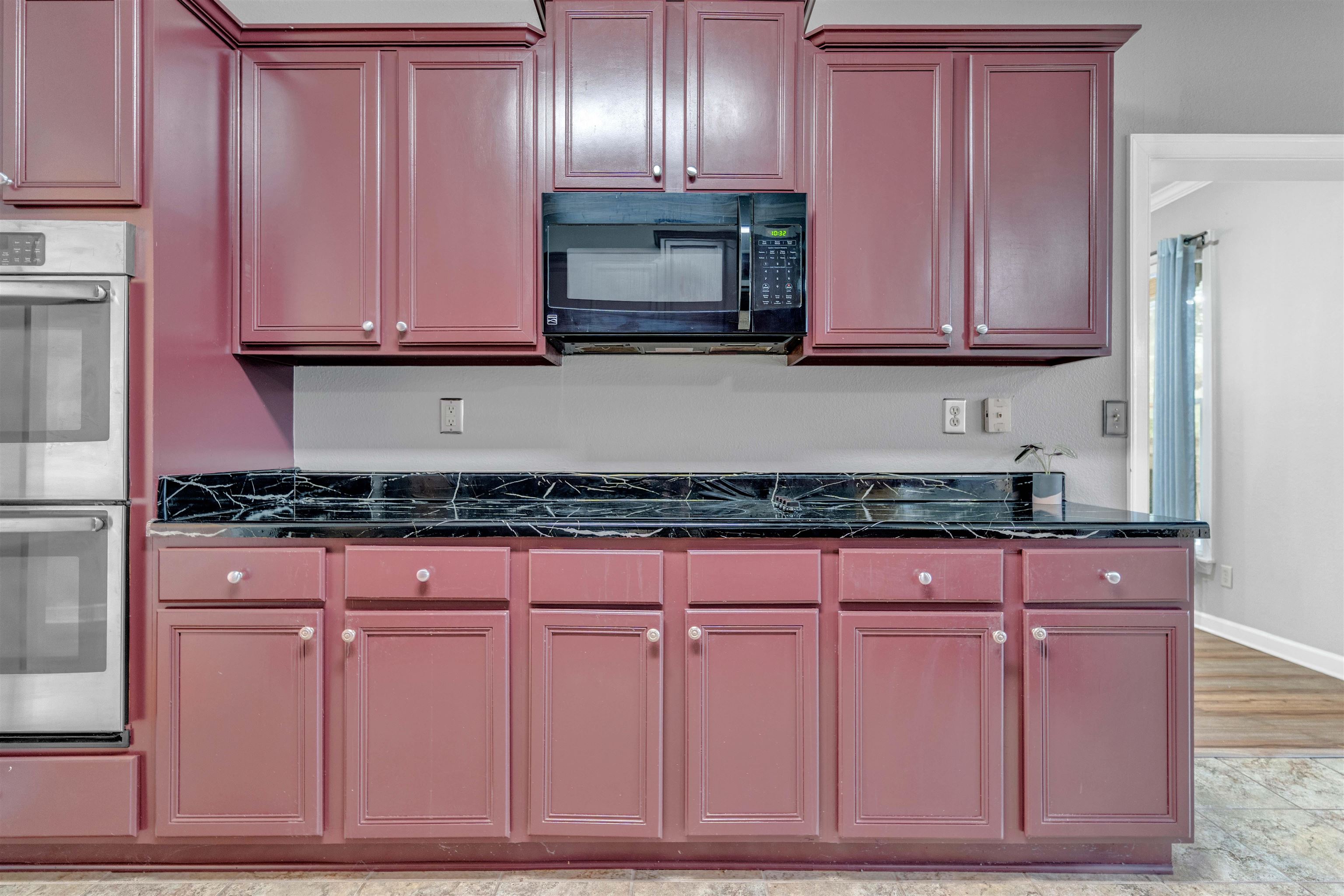 1335 Riding Brook Drive Collierville, TN 38017 - Photo 8 of 32 a kitchen with granite countertop cabinets and stainless steel appliances granite counter tops