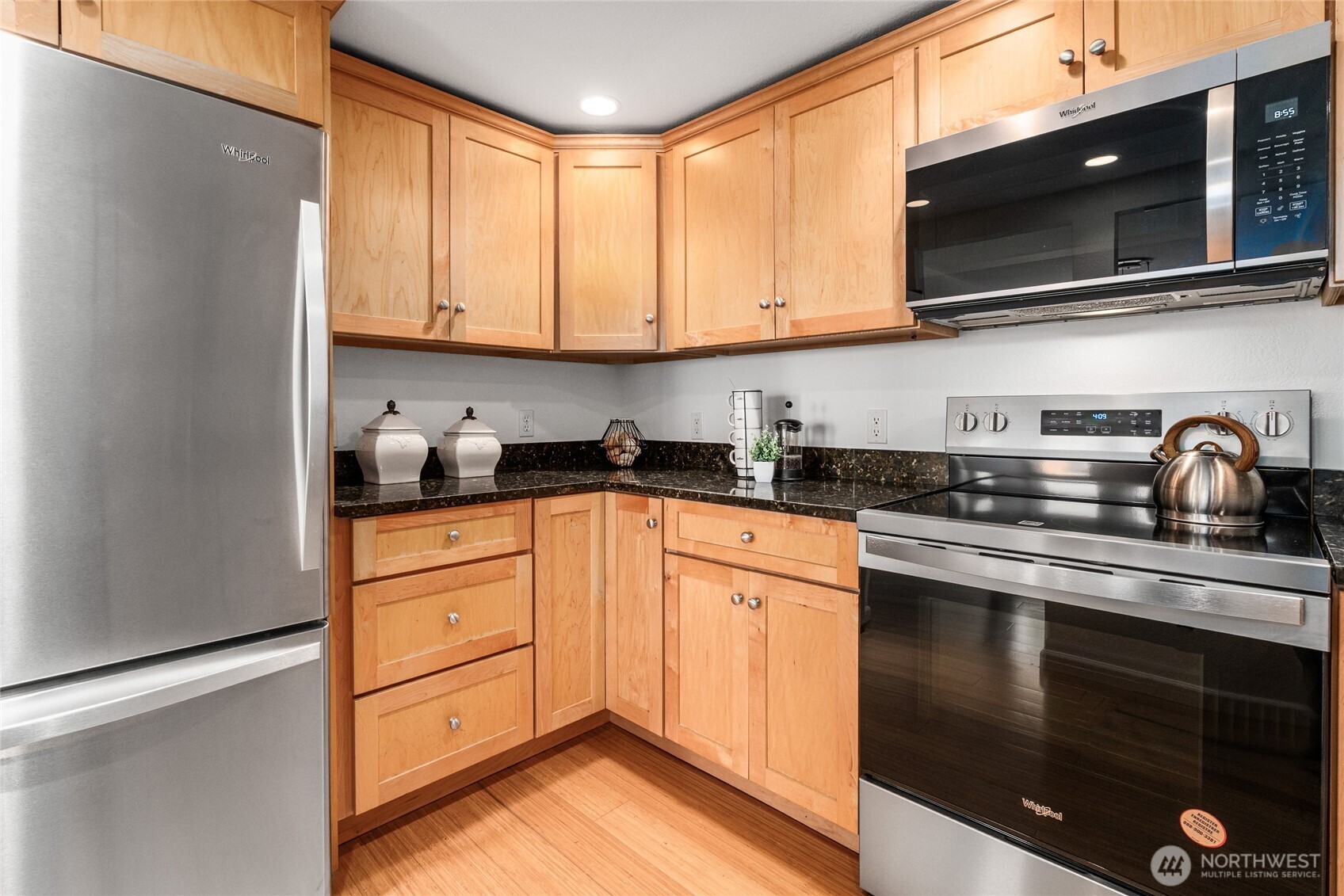 410 West Roy Street, Unit E101 Seattle, WA 98119 - Photo 16 of 33 a kitchen with stainless steel appliances granite countertop a stove a sink and a microwave